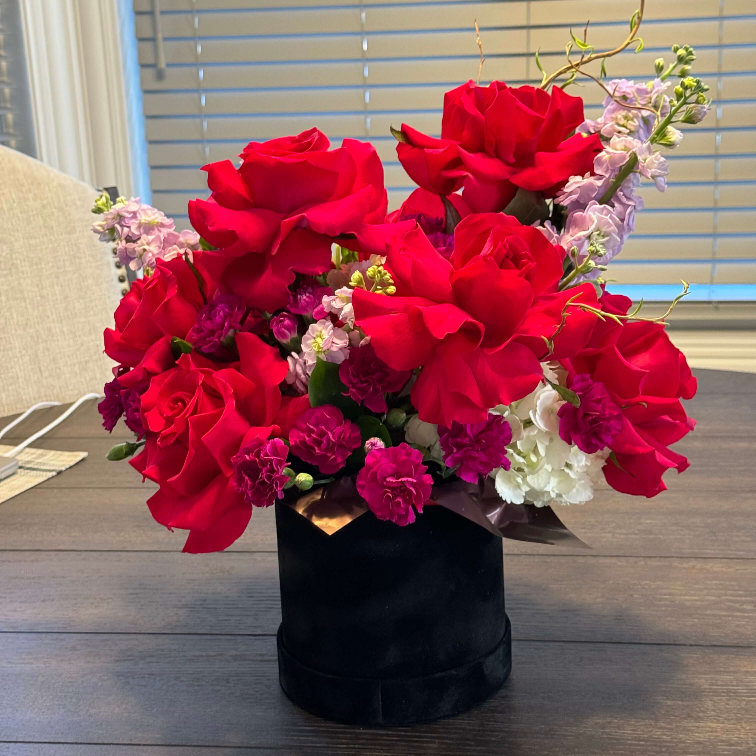 A luxurious bouquet featuring lush red roses in a romantic velvet box, designed for special occasions.