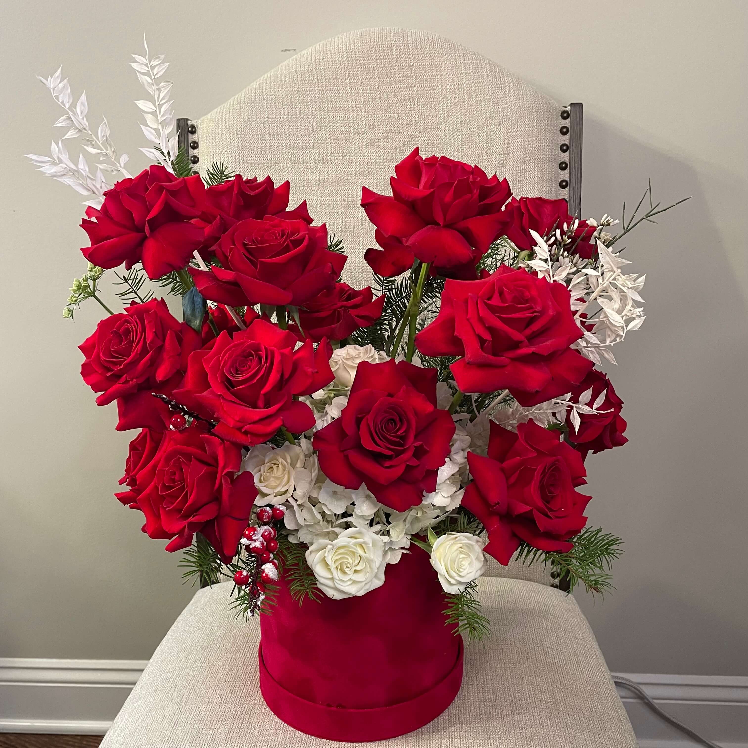 A romantic bouquet with red roses and white tulips, in a red boxes for a perfect gift.